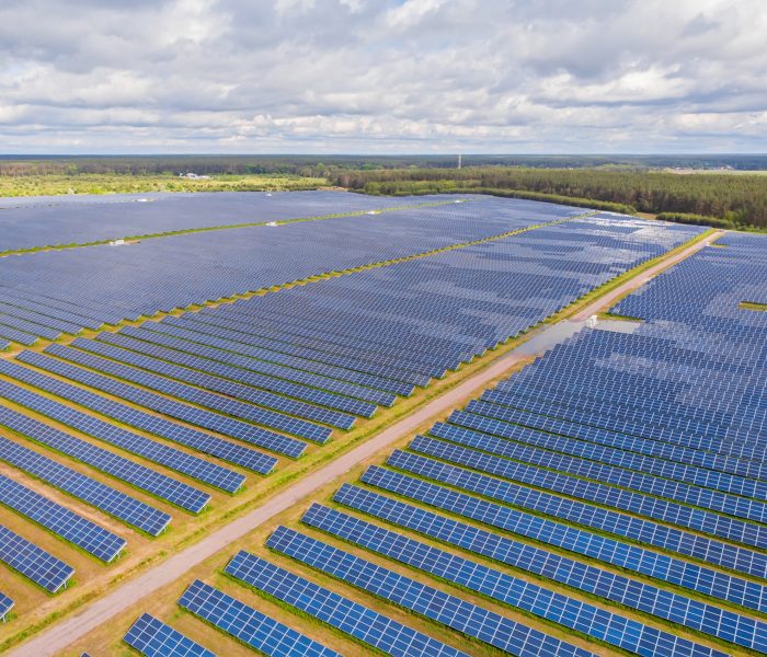 Solar panel produces green, environmentaly friendly energy from the setting sun. Aerial view from drone. Landscape picture of a solar plant that is located inside a valley